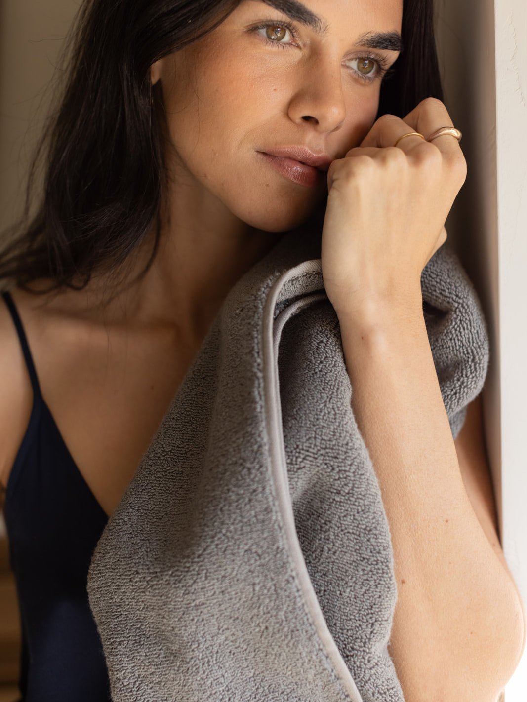 Woman holding charcoal luxe bath sheet 