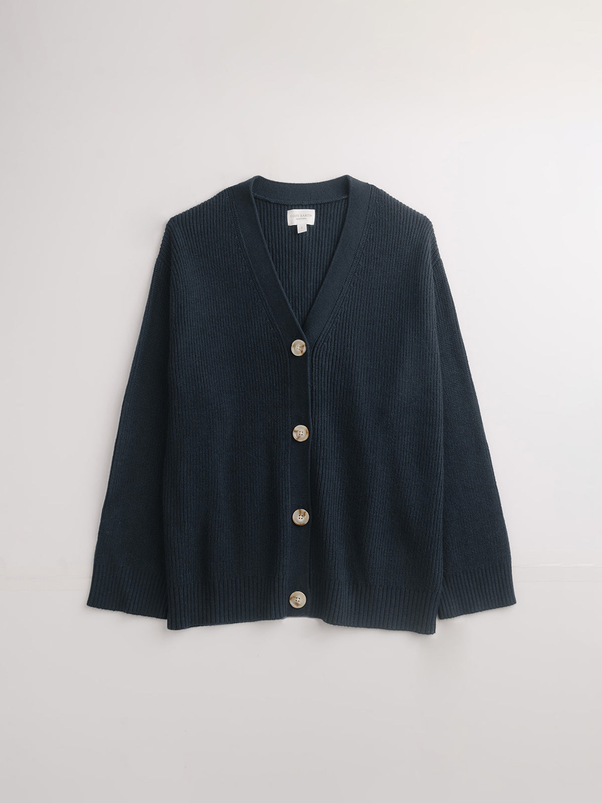 Flat lay of eclipse cardigan with white background 
