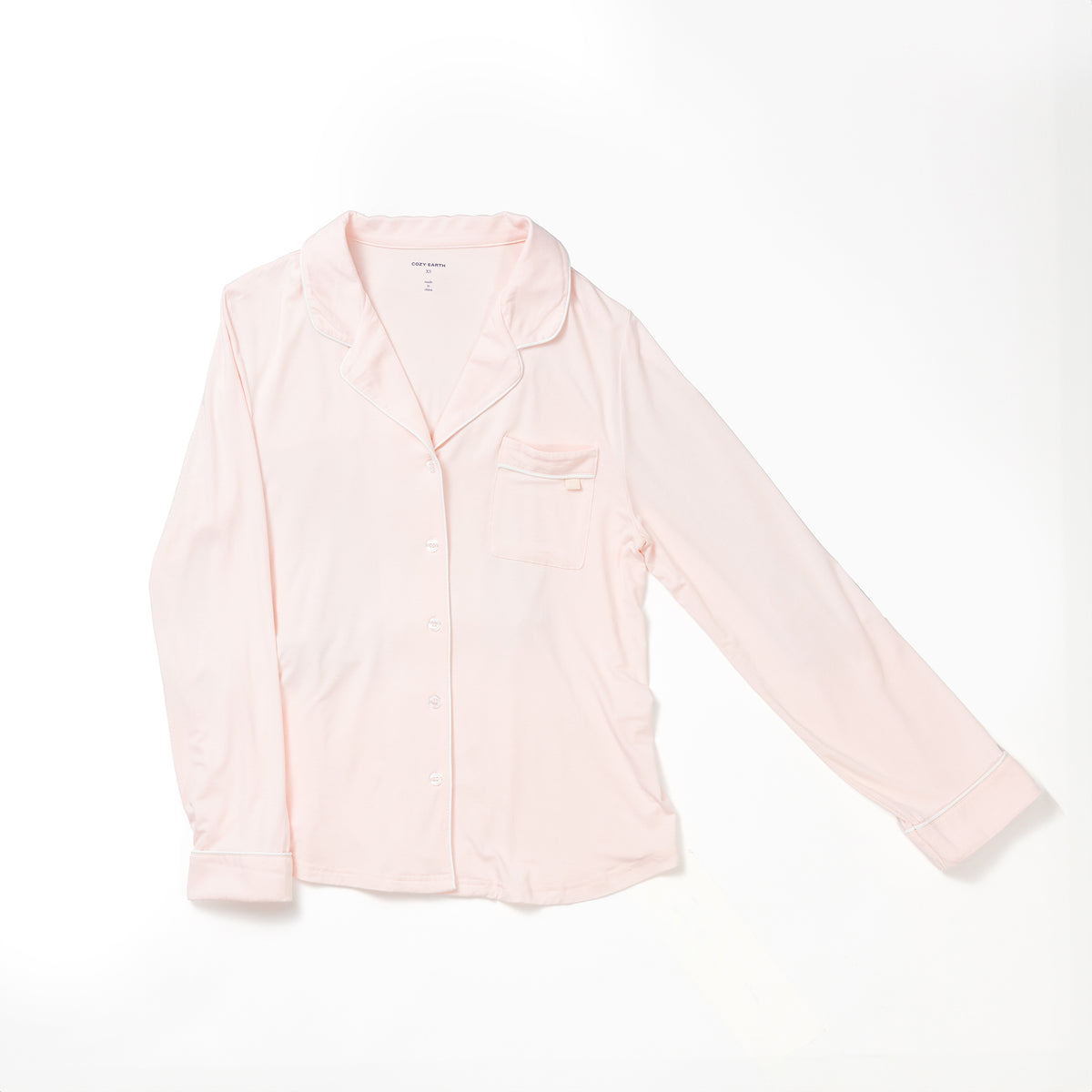 A Women's Long Sleeve Bamboo Pajama Top in Stretch-Knit TALL from HIDE, featuring a light pink color, long sleeves, a button-down front with a collar, and a small chest pocket. The fabric appears soft and comfortable as the shirt is displayed flat against a white background. 