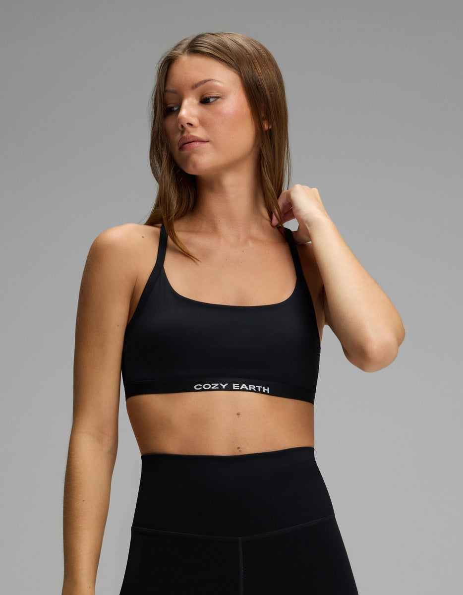 A person wearing a black, scoop-neck Women’s Balance Bra by Cozy Earth with a branded elastic band.
