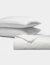 The Cozy Earth Bamboo Insert Bundle features two plush white pillows stacked beside a neatly folded white comforter, all displayed on a plain white background.|Filling:Standard
