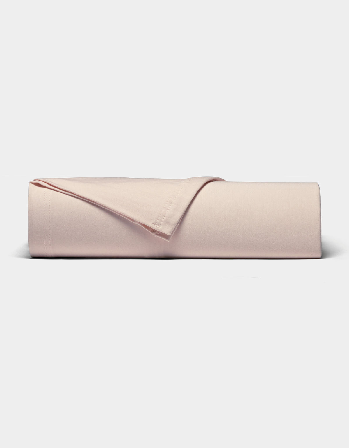 The Cozy Earth Bamboo Jersey Sheet Set, in light pink, is neatly folded and displayed on a plain white background.