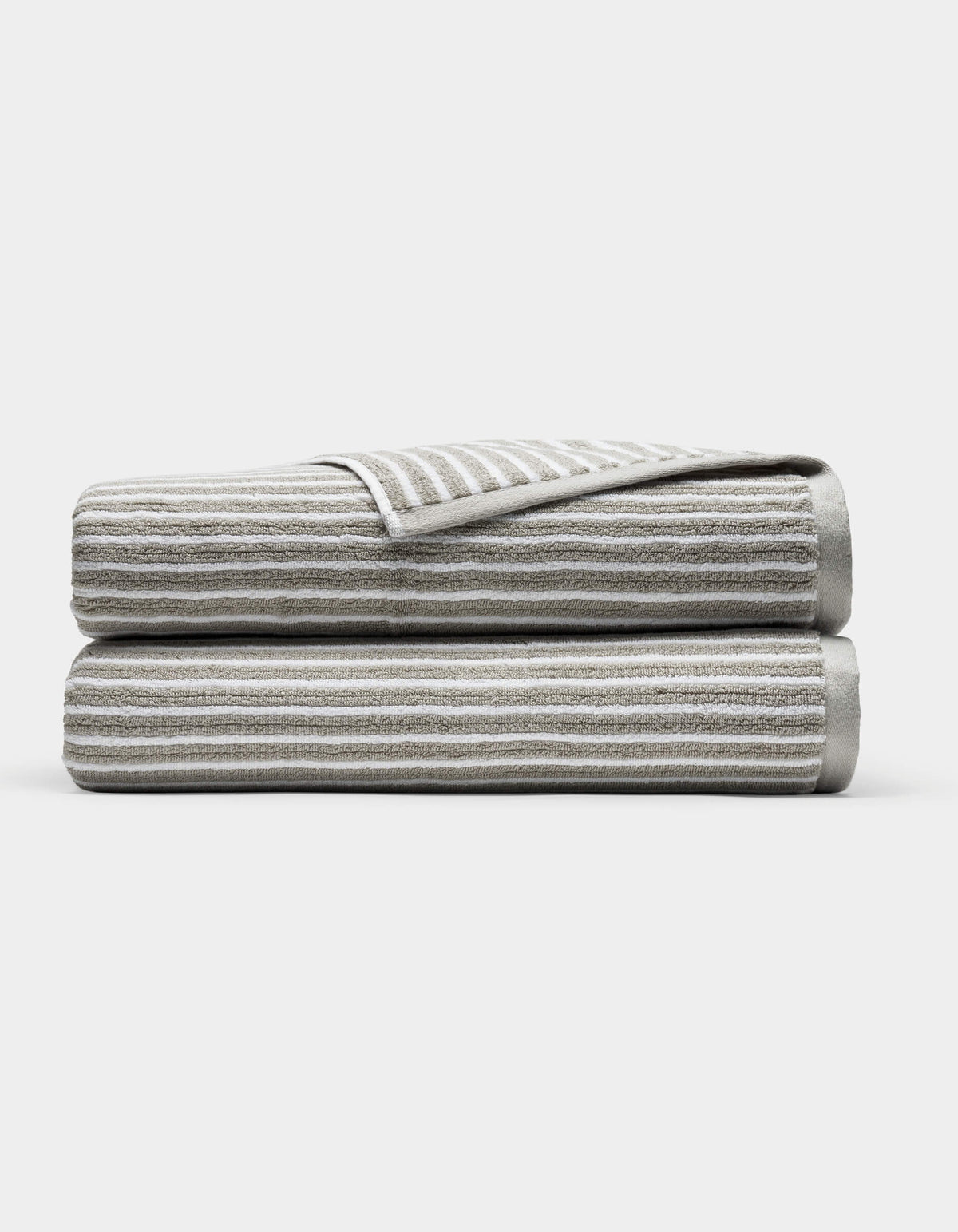 Two Cozy Earth Ribbed Terry Bath Sheets in gray and white stripes are folded and stacked on each other against a plain white background.
