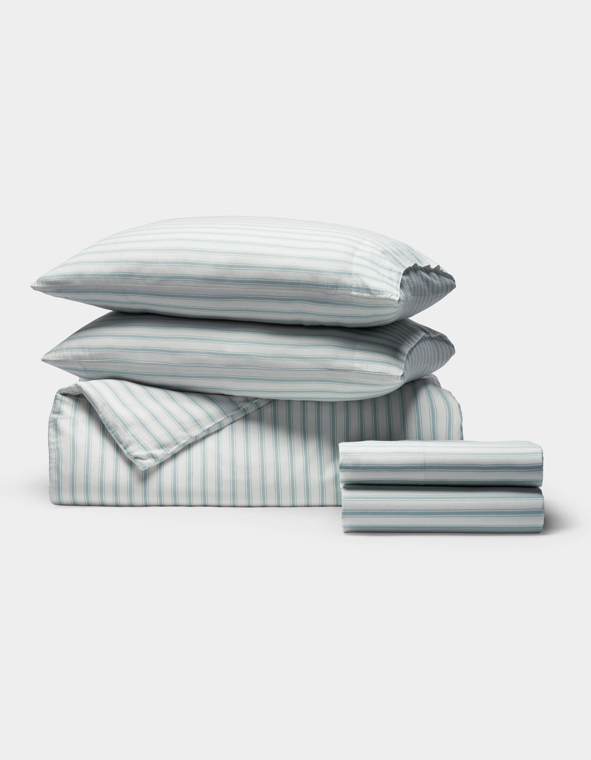The Cozy Earth Soft-Wash Cotton Bedding Deluxe Bundle includes two pillows, a comforter, and sheets, all neatly folded with a light blue and white vertical stripe pattern.|Color:River and Sea Salt Stripe