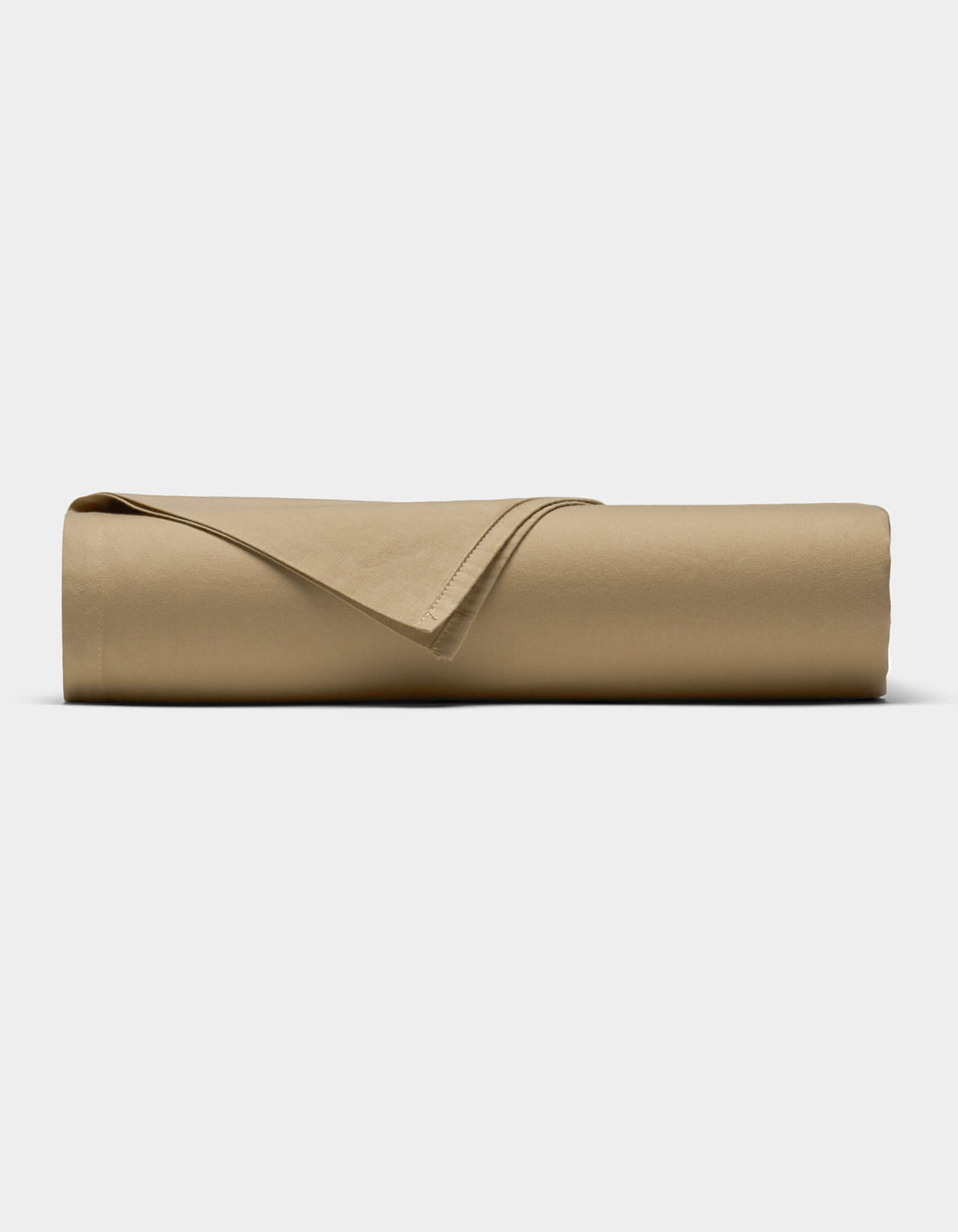 The Soft-Wash Cotton Sheet Set by Cozy Earth in tan is neatly rolled into a cylinder, with one corner folded back, displayed against a plain white background.|Color:Sandalwood