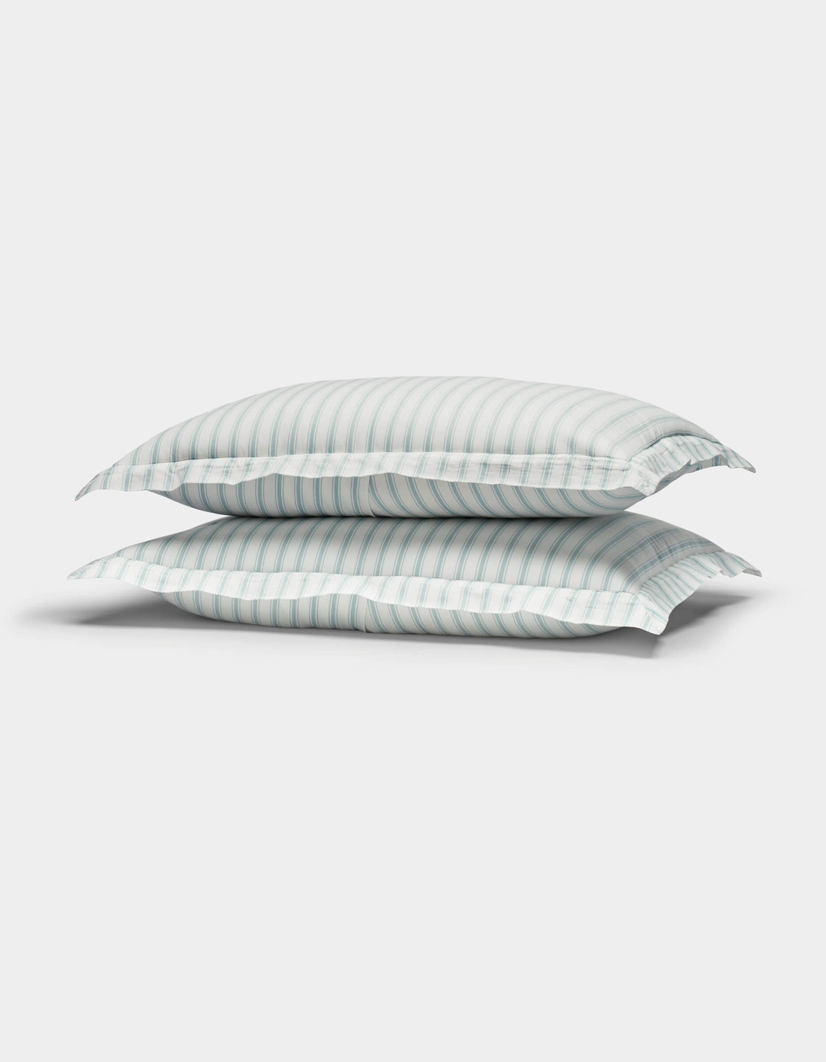 Two Cozy Earth Soft-Wash Cotton Quilted Shams in white with light blue and gray stripes are stacked together against a plain white background.