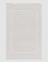 The Cozy Earth Classic Bath Mat features a rectangular shape, light color, subtle textured pattern, and elegant double border design on the edges.|Color:Light Grey