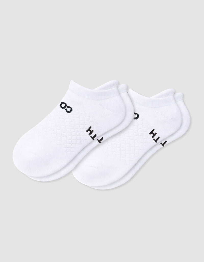 The Women's Essential Ankle Sock by Cozy Earth features a textured white design with subtle black text near the cuff, shown on a light gray background.