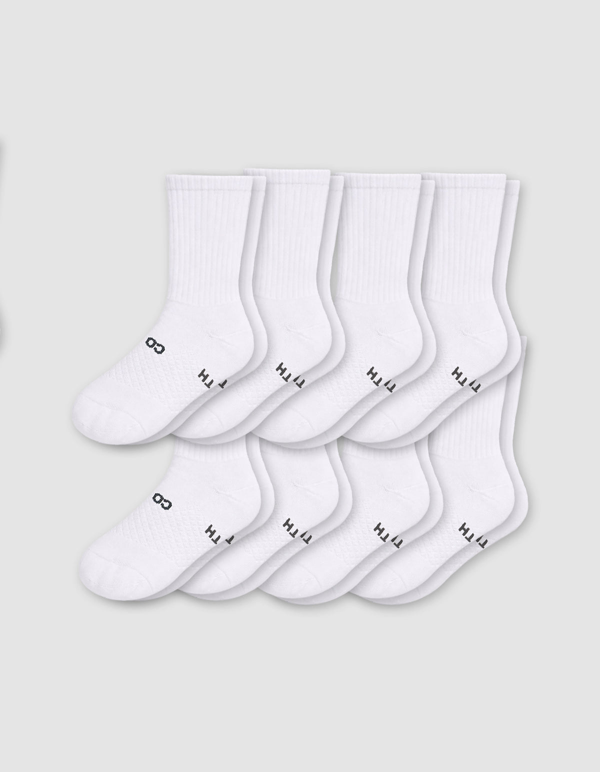 Eight pairs from the Cozy Earth Men's Essential Calf Sock 8-Pack are displayed in two neat overlapping rows on a light gray background, each featuring small black text and symbols near the toes.|Color:White
