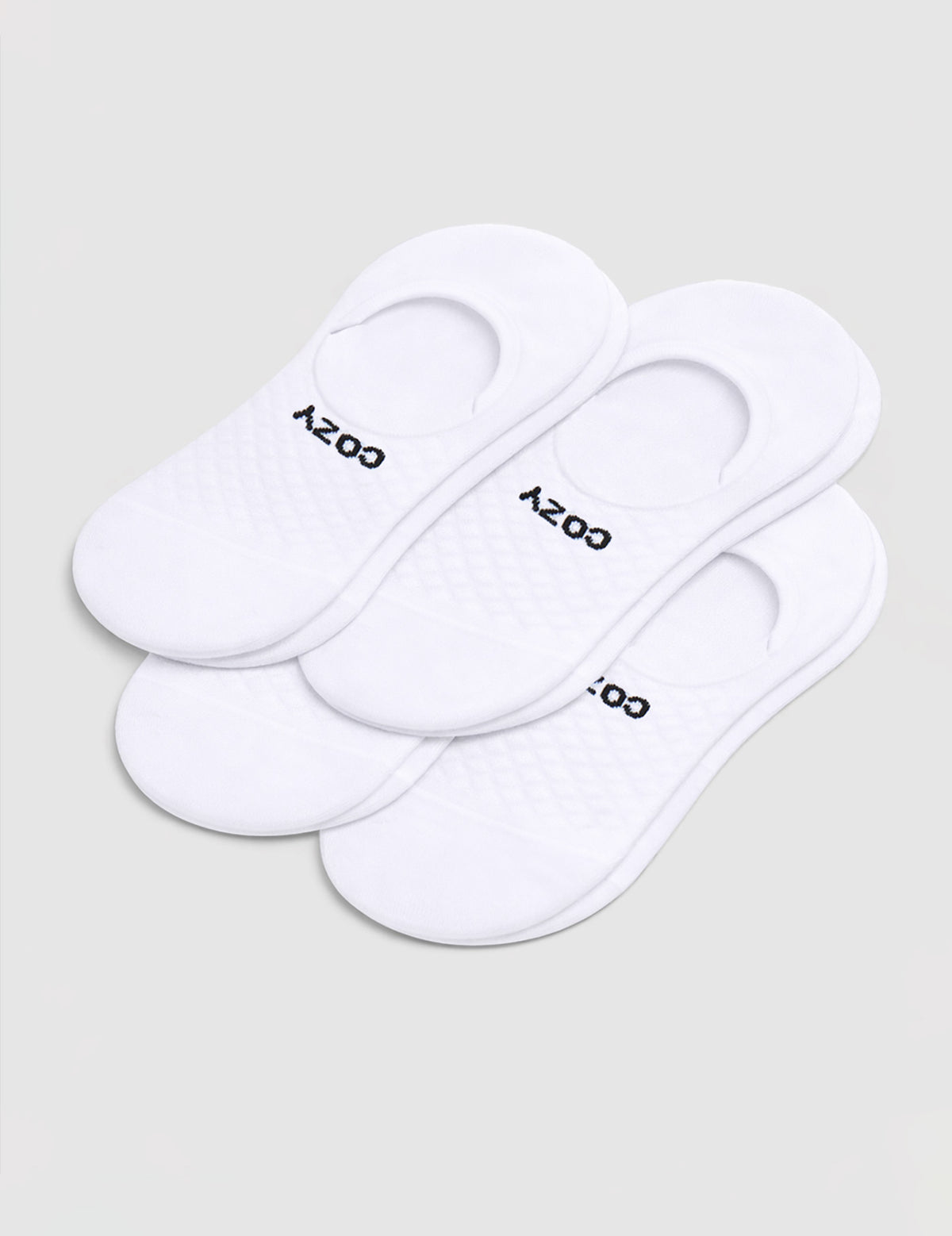 A 4-pack of white Men's Essential No-Show Socks by Cozy Earth, each pair featuring "COZY" in black, displayed on a plain white background.|Color:White