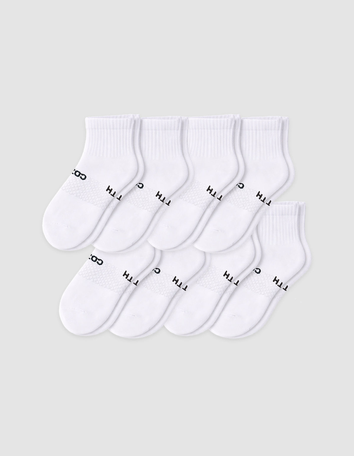 The Cozy Earth Men's Essential Quarter Sock 8-Pack features eight pairs of white socks with ribbed cuffs, neatly arranged in overlapping rows. Some have black text near the toe area, all displayed on a plain light background.