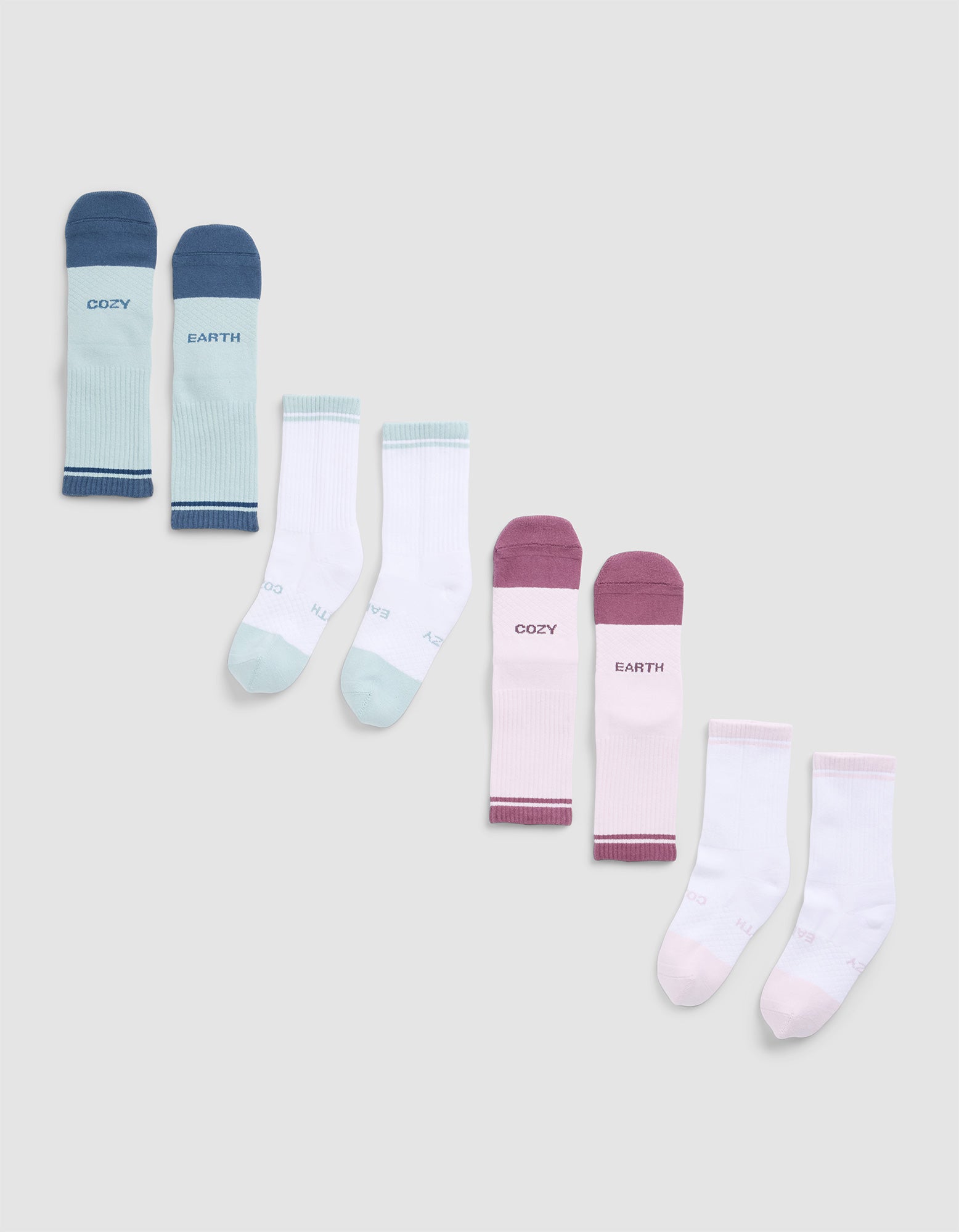 Four pairs of Cozy Earth Essential Calf Socks in blue, mint green, burgundy, and light pink—each featuring text on the tops—are arranged in a row on a light grey background.|Color:Arctic/Lilac