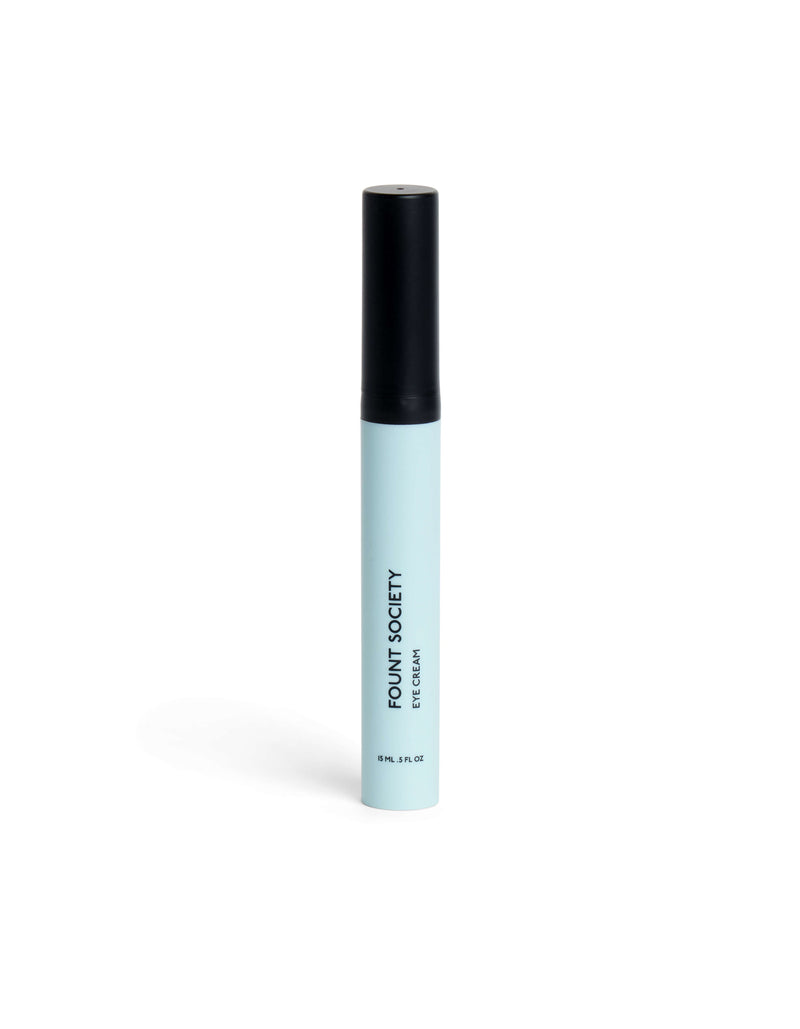 A light blue cylindrical tube with a black cap, labeled "Cozy Earth Eye Cream" in black text, stands upright on a white background.
