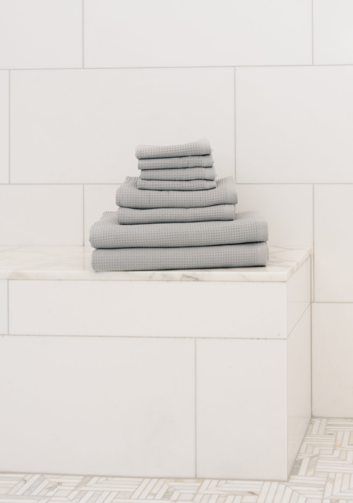 Waffle Bath Towel Set in the color Harbor Mist. Photo of Harbor Mist Waffle Bath Towel Set taken resting on a marble counter top. 