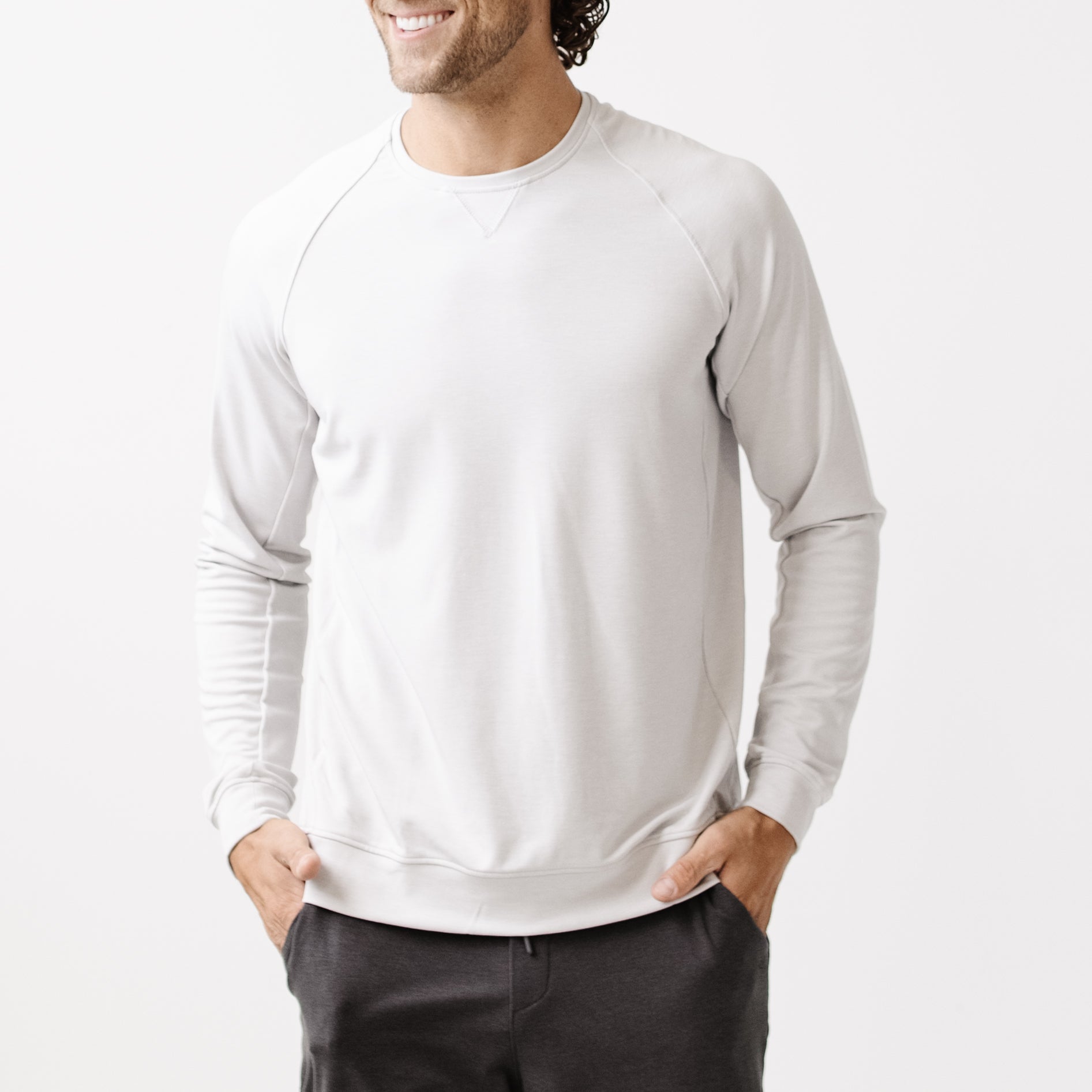 Light Grey/Charcoal Men's Bamboo Jogger Set. There is a man wearing the jogger set. He is standing in a well lit room in a home.|Color:Light Grey