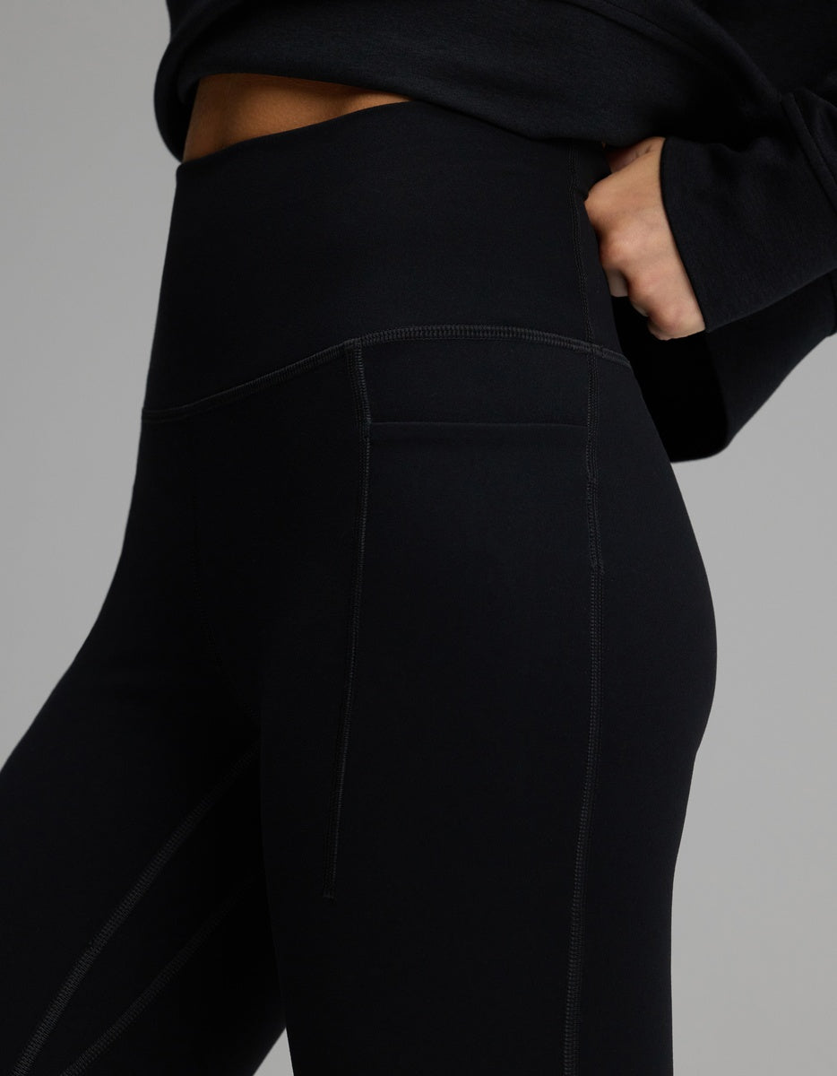 Close-up of black high-waisted Women’s Liv Leggings with Pockets featuring a side pocket and visible seam detailing.|Color:Jet Black
