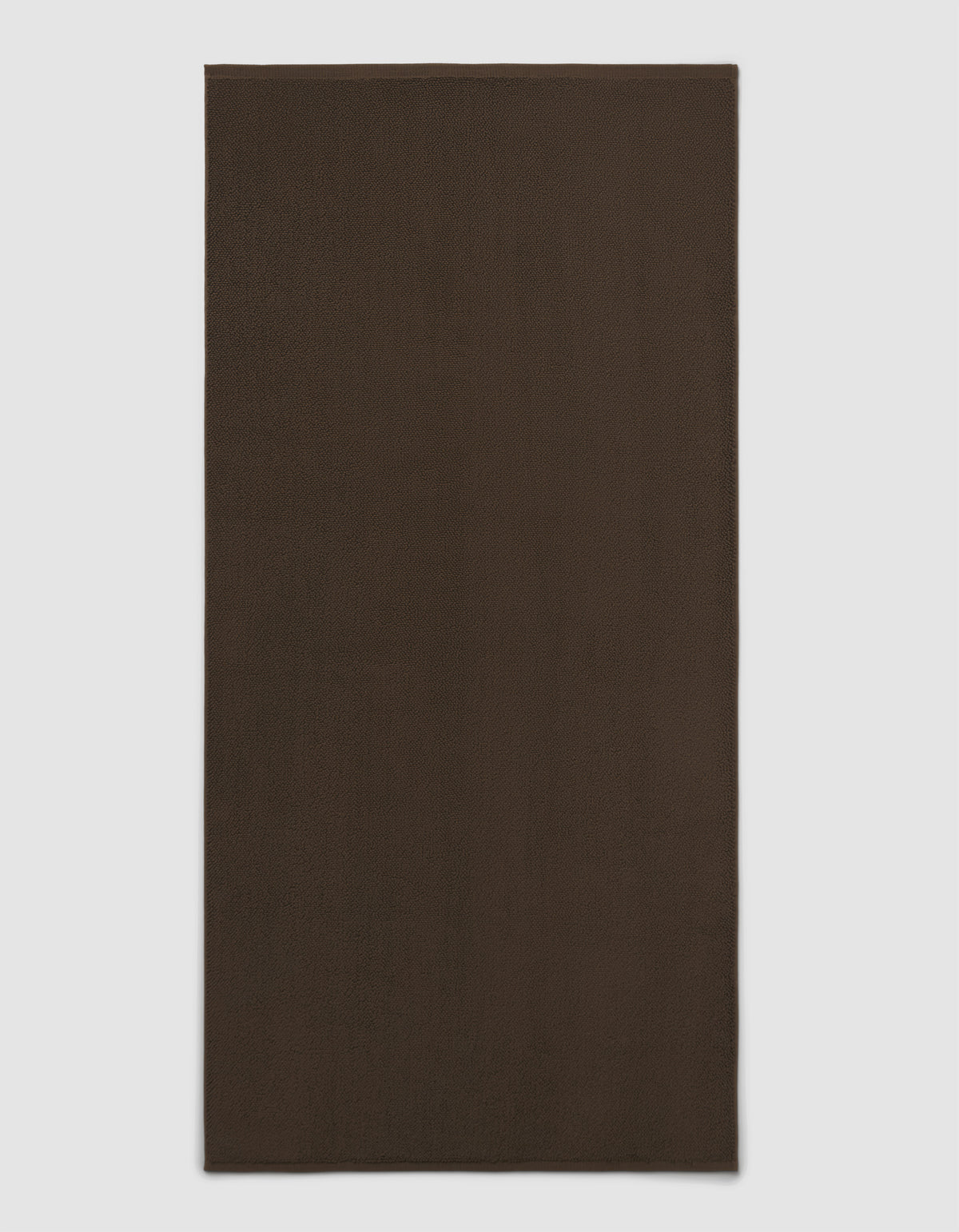 The Cozy Earth Loop Terry Bath Mat is shown on a light gray background. This plain, rectangular bath mat features a dark brown, solid color design without patterns or visible texture.|Color:Espresso