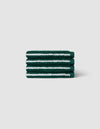 A stack of four Luxe Washcloths by Cozy Earth in dark green with white stripes, displayed against a light gray background.|Color:Uniform with Seashell Stripe