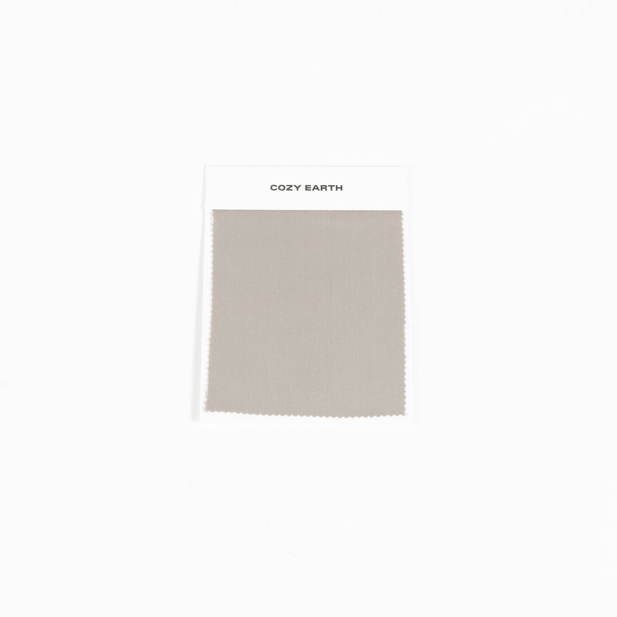 A swatch from the Bamboo Sheet collection by Cozy Earth is shown against a white background. It features a white label at the top with the brand name, "COZY EARTH. 