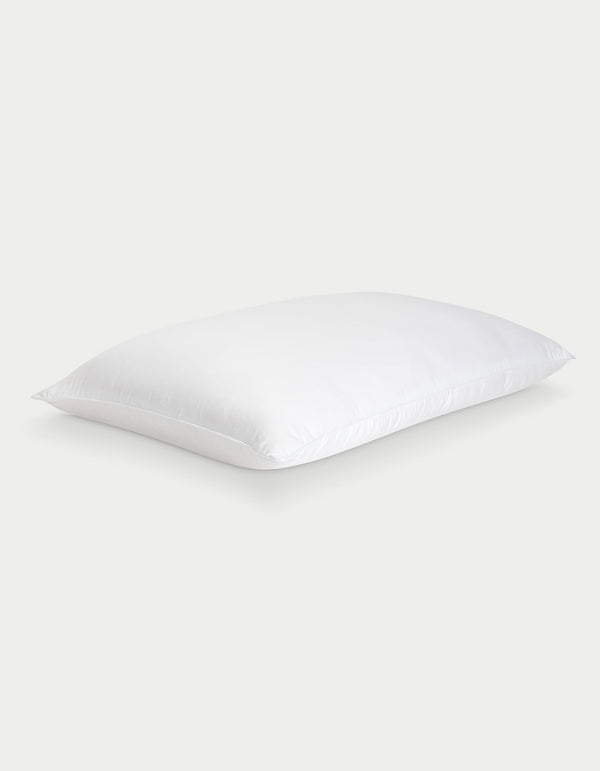 The Cozy Earth Silk Pillow, soft and rectangular with neatly finished edges, is shown against a light gray background. Its smooth white fabric highlights the luxurious feel of this premium pillow.