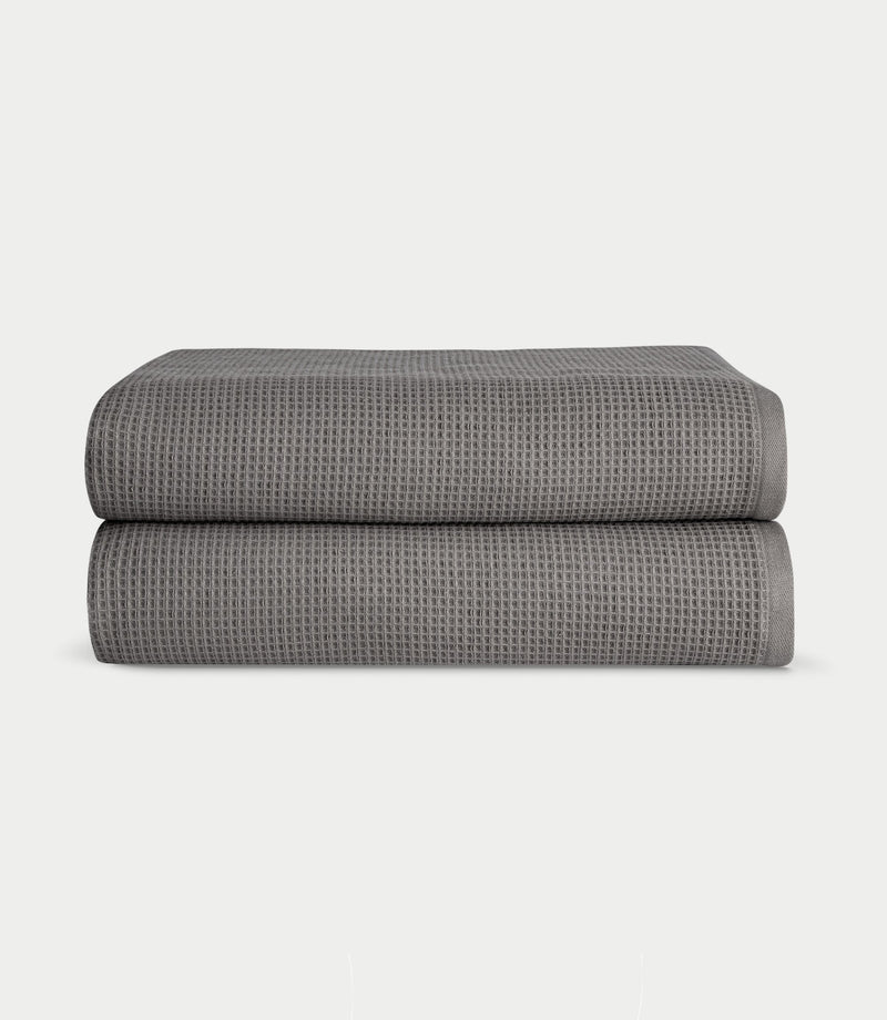 Waffle Bath Sheets in the color Charcoal. Photo of Waffle Bath Sheets taken with white a background.