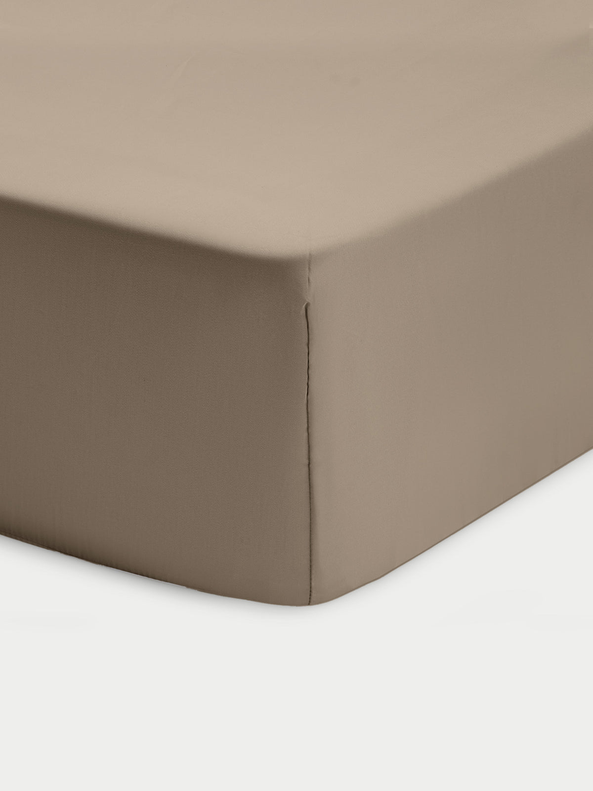 Corner of walnut crib sheet with white background 