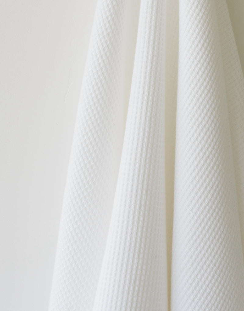 Waffle Bath Towel in the color White. Photo of White Waffle Bath Towel taken as a close up of the White Waffle Bath Towel. The picture shows only the towel