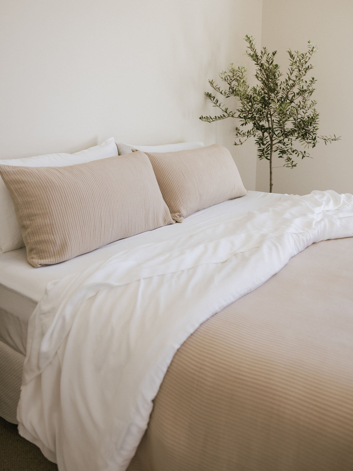 Driftwood coverlet and shams on a bed 