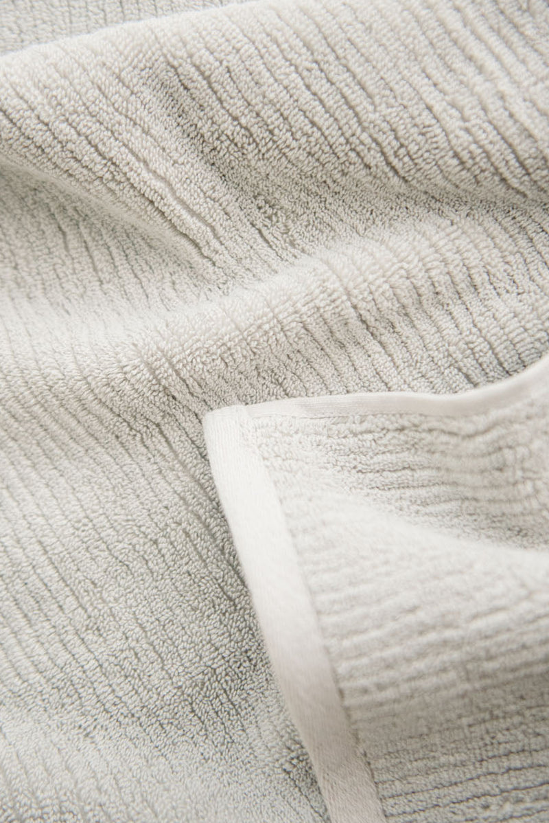 Ribbed Terry Hand Towels in the color Light Grey. Photo of product taken as a close up.