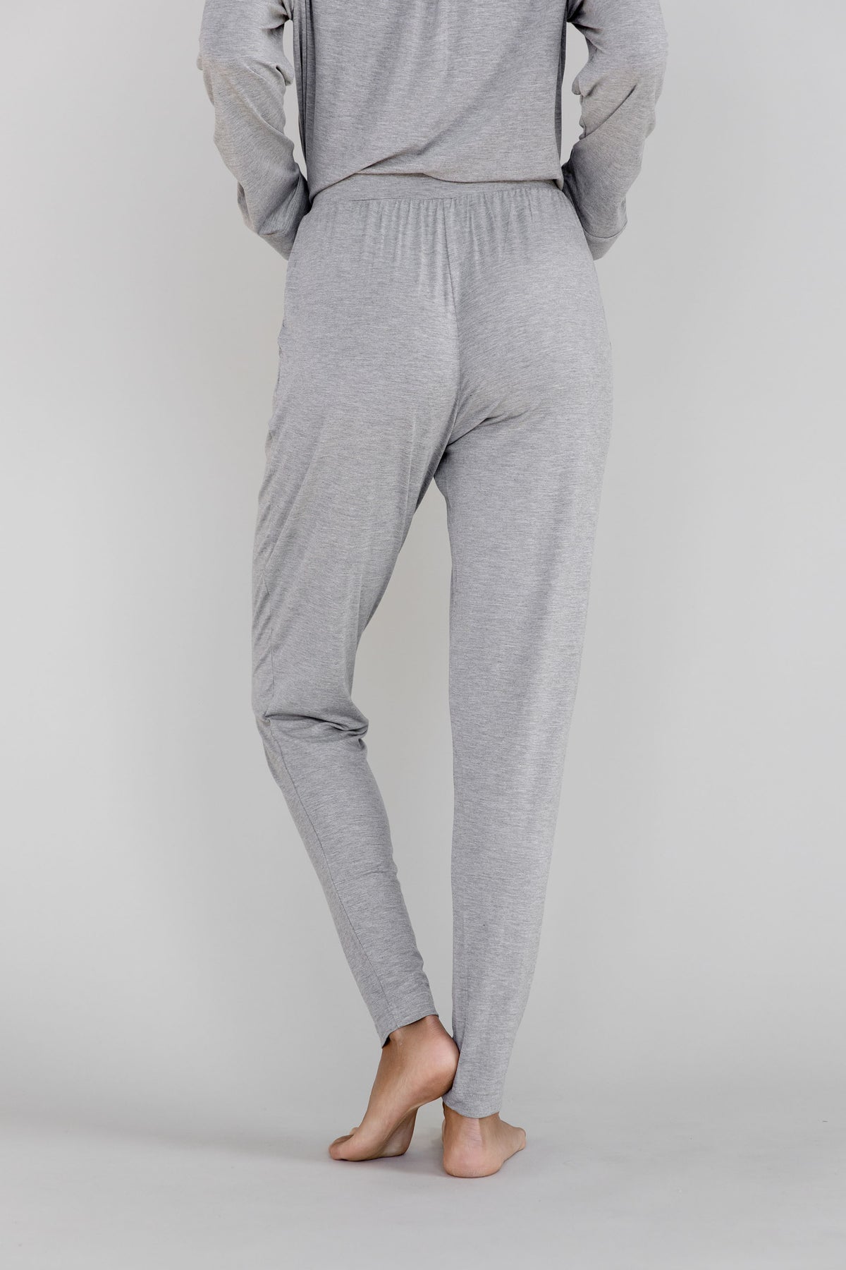 Gray Cozy Earth Stretch Knit Tapered Pant set worn by a person facing backward on a light gray background 